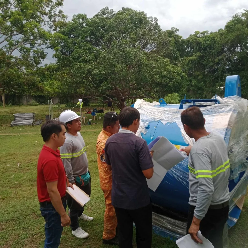 Mechanical and Electrical Engineering workers reviewing blueprints for smoke extraction blower